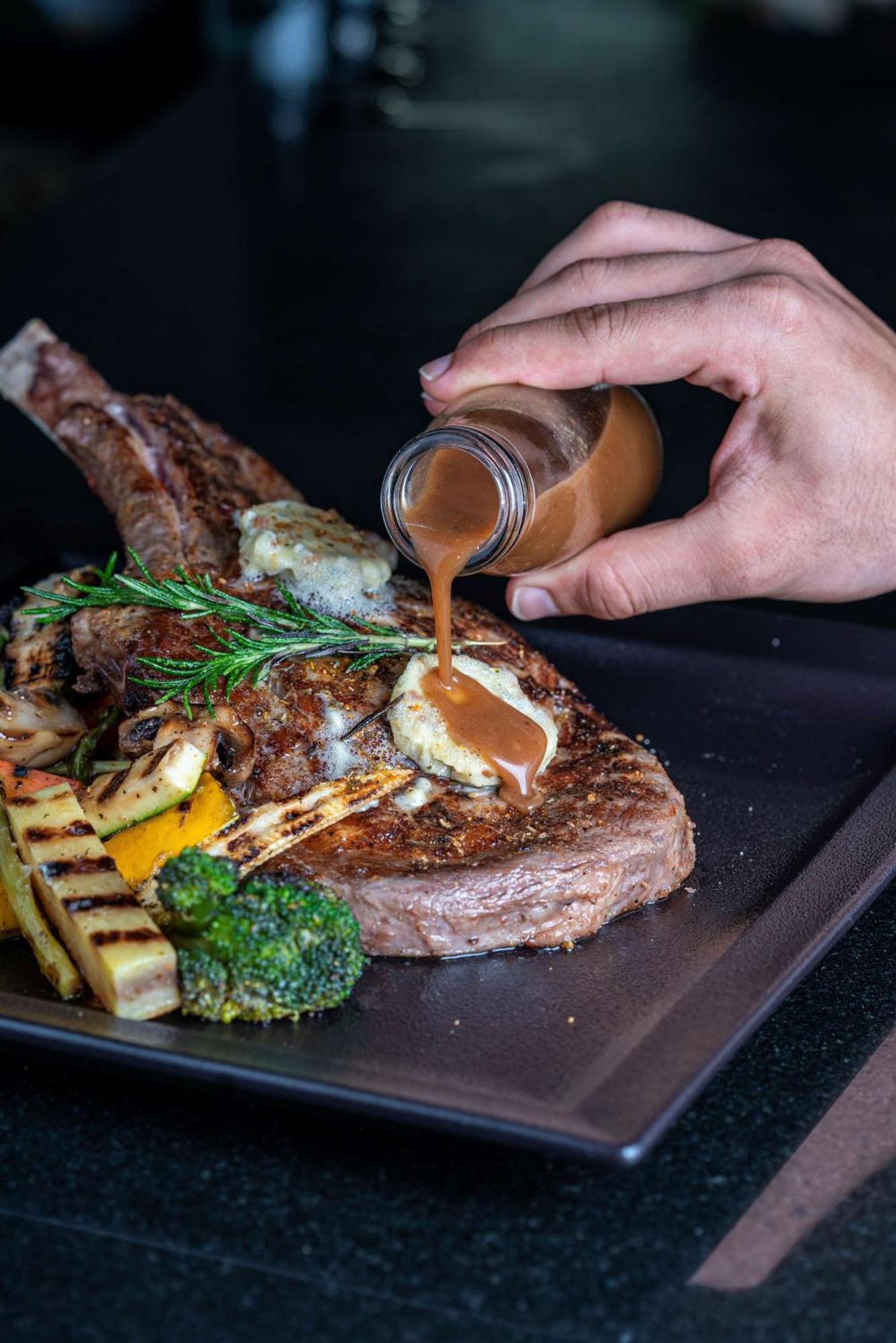Radisson Blu Hotel & Resort, Sohar Ngoại thất bức ảnh A steak being drizzled with a sauce